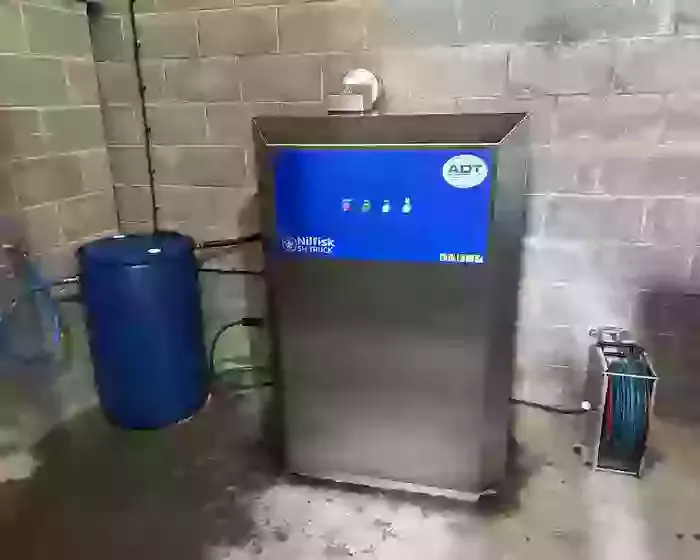 Nilfisk SH Truck stainless static hot pressure washer installed at a Twycross farm for cleaning ATV equipment, with 200L water barrel and boost pump modification.